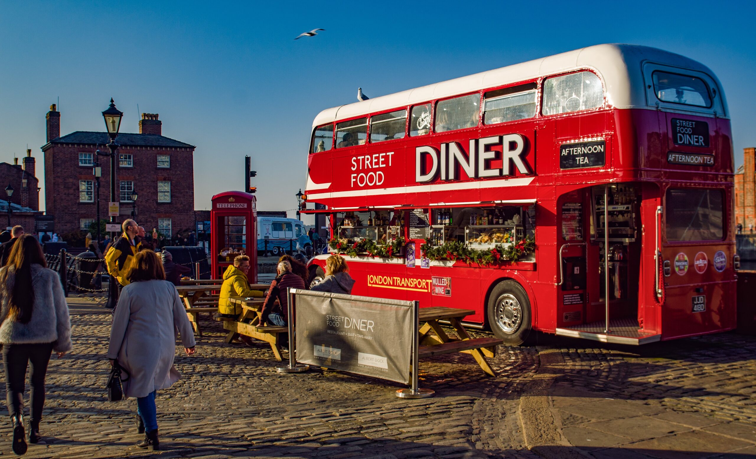 red double deck bus Diner street food park near buildings